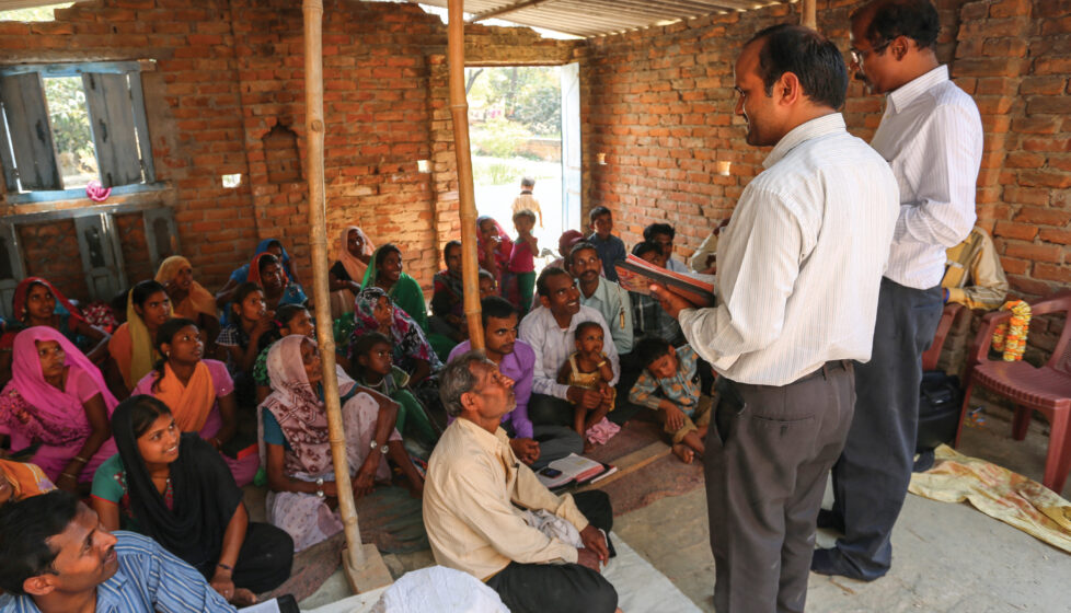 Two man leading a church service in a house