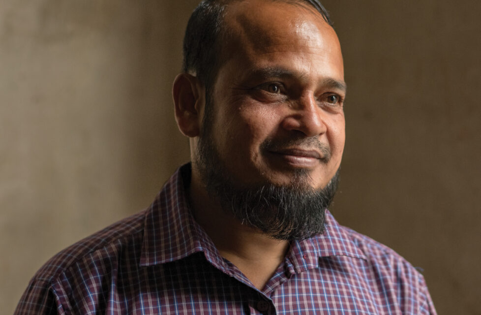 Man smiles at person off camera