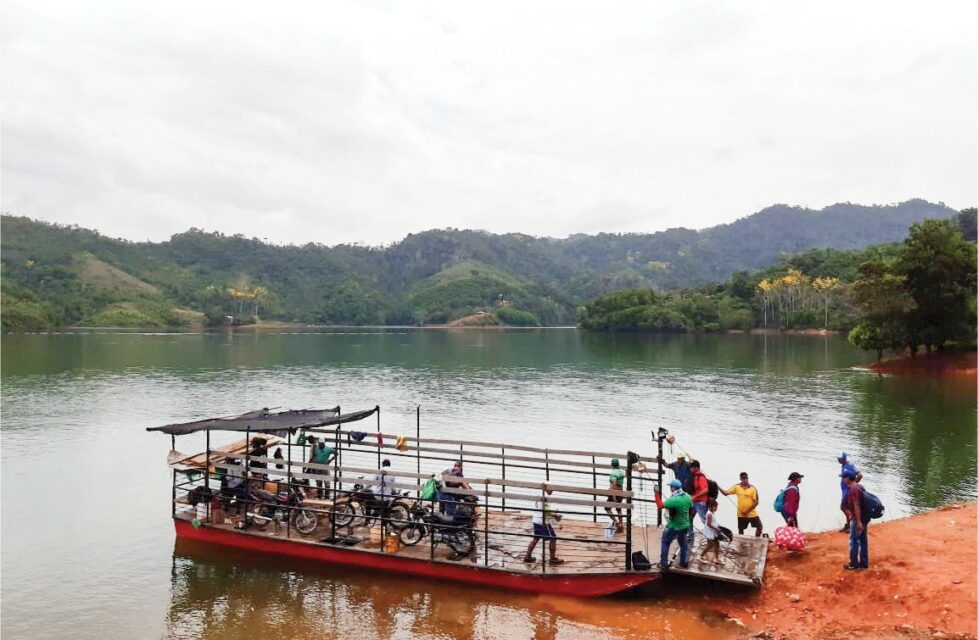 Colombian front line workers load bibles onto a boat