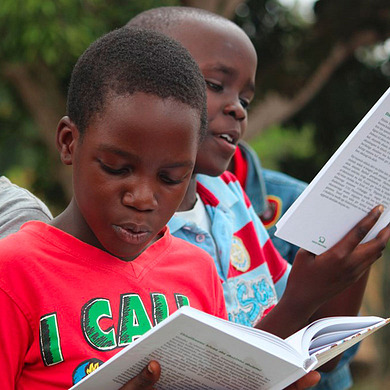 Two boys reading books